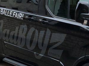KFZ-Beklebung - Detail der Seitenansicht eines schwarzen Transporters mit einer neuen großflächigen Fahrzeugbeklebung von Badboyz Ballfabrik